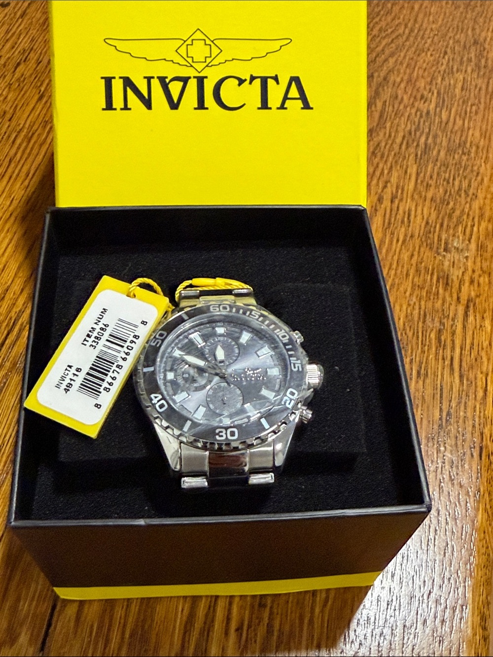 Invicta Men's Silver Watch with Black Dial and Yellow Accent Tag